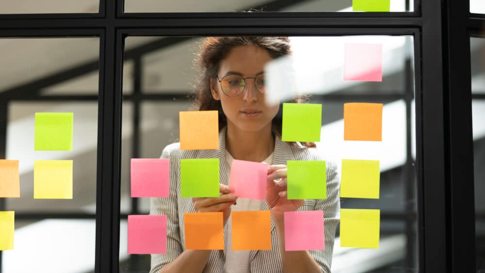 Woman Adding Notes on Sticky Papers