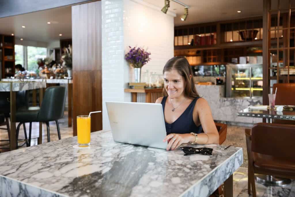 Woman working on a laptop in an upscale cafe