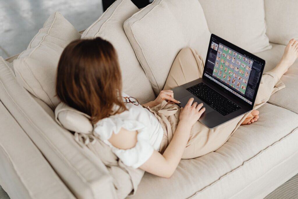 Woman relaxing on a couch with a laptop