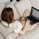 Woman relaxing on a couch with a laptop