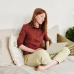 Woman working on a laptop on a couch