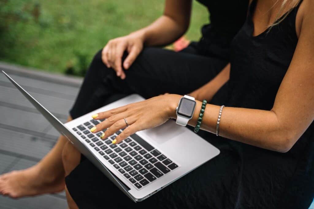 Person typing on a laptop outdoors