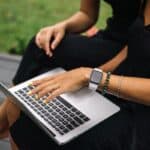 Person typing on a laptop outdoors
