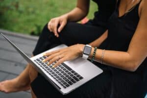 Person typing on a laptop outdoors